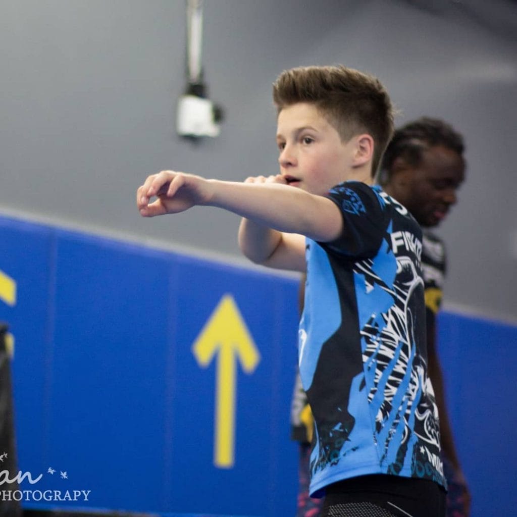boy boxing in Muay Thai class