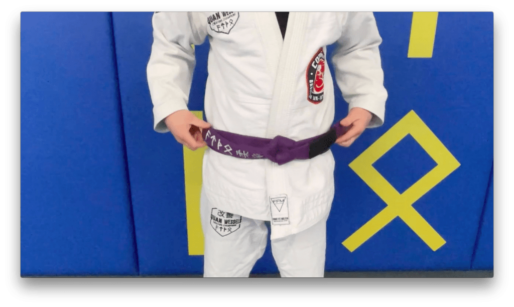 A purple belt being tied